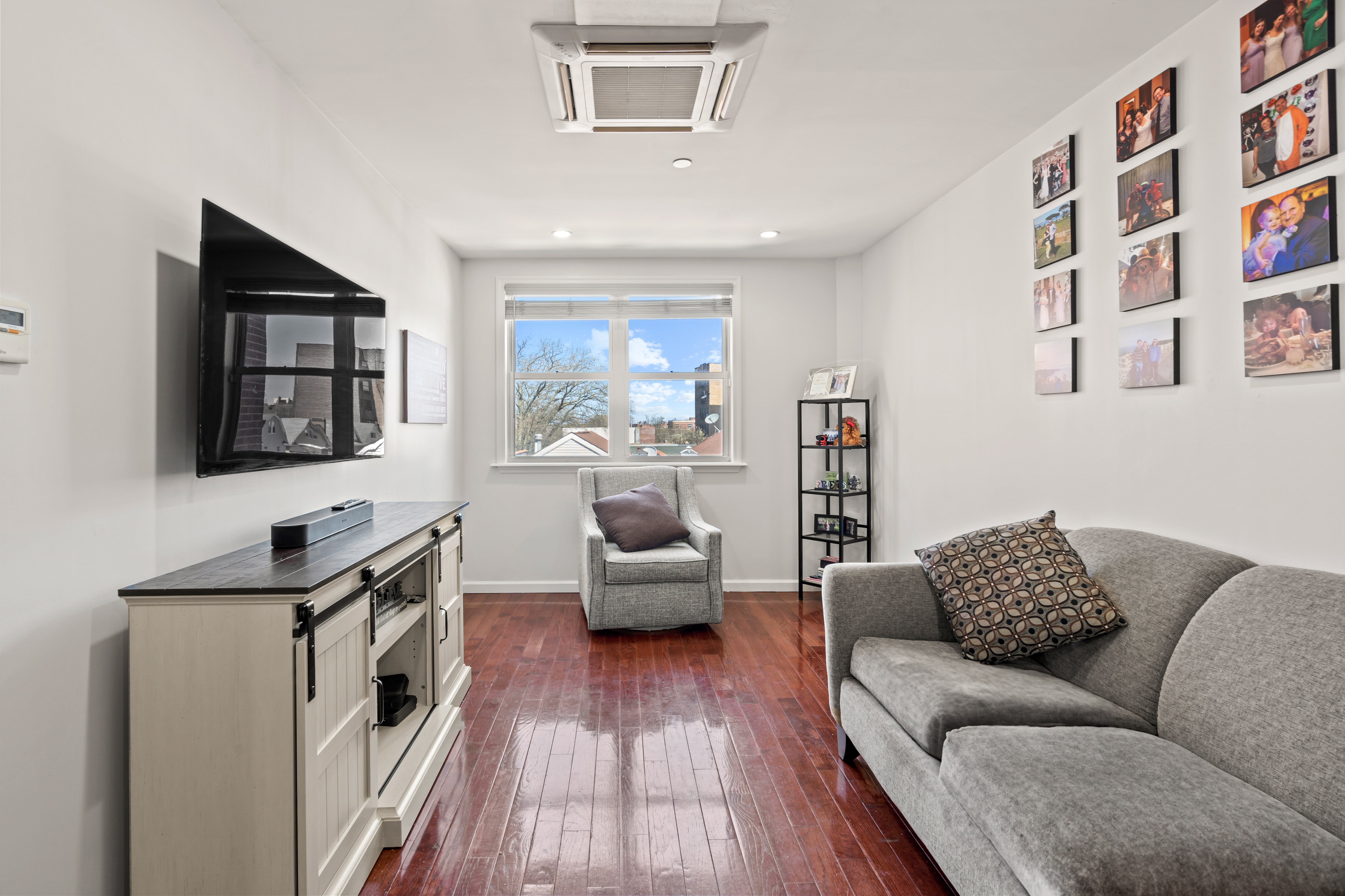 65-33 38th Avenue, Unit 5 Queens, NY 11377 - Photo 3 of 23 a living room with furniture and a wooden floor
