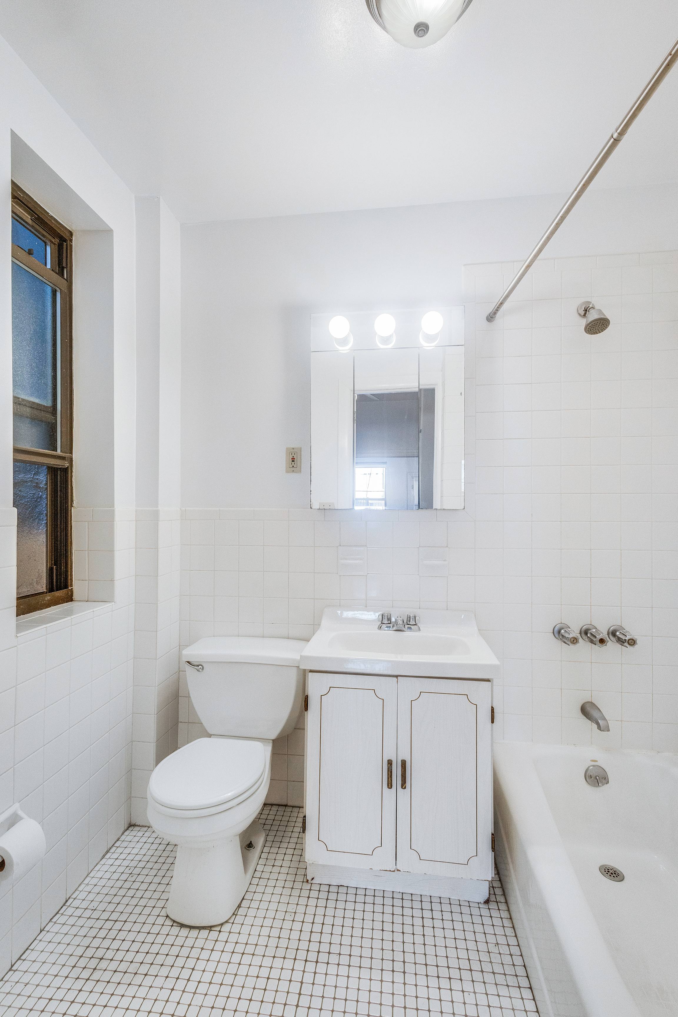 167 West 72nd Street Manhattan, NY 10023 - Photo 10 of 25 a bathroom with a sink a toilet and shower