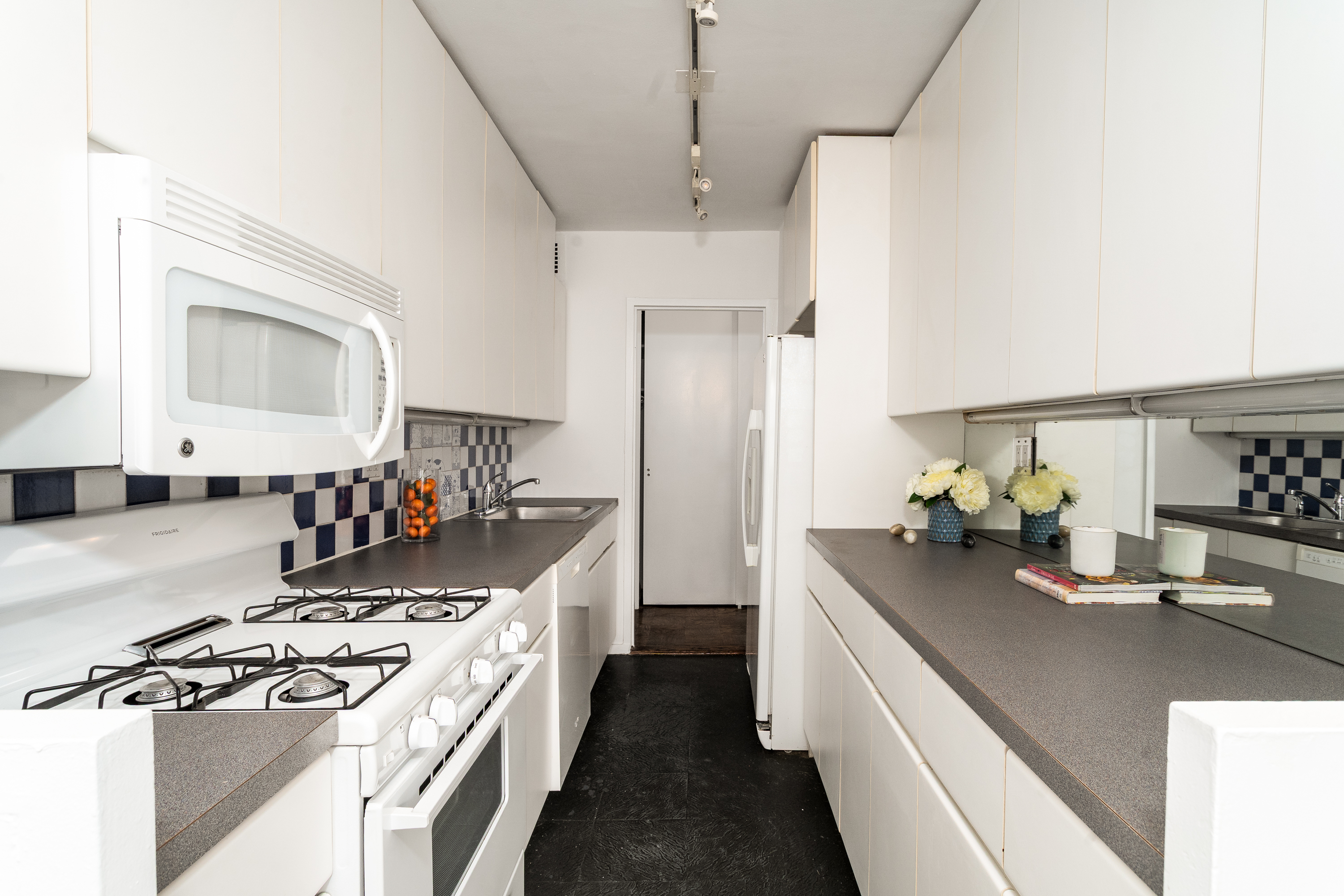 180 West End Avenue, Unit 23D Manhattan, NY 10023 - Photo 6 of 22 a kitchen with a stove and a sink