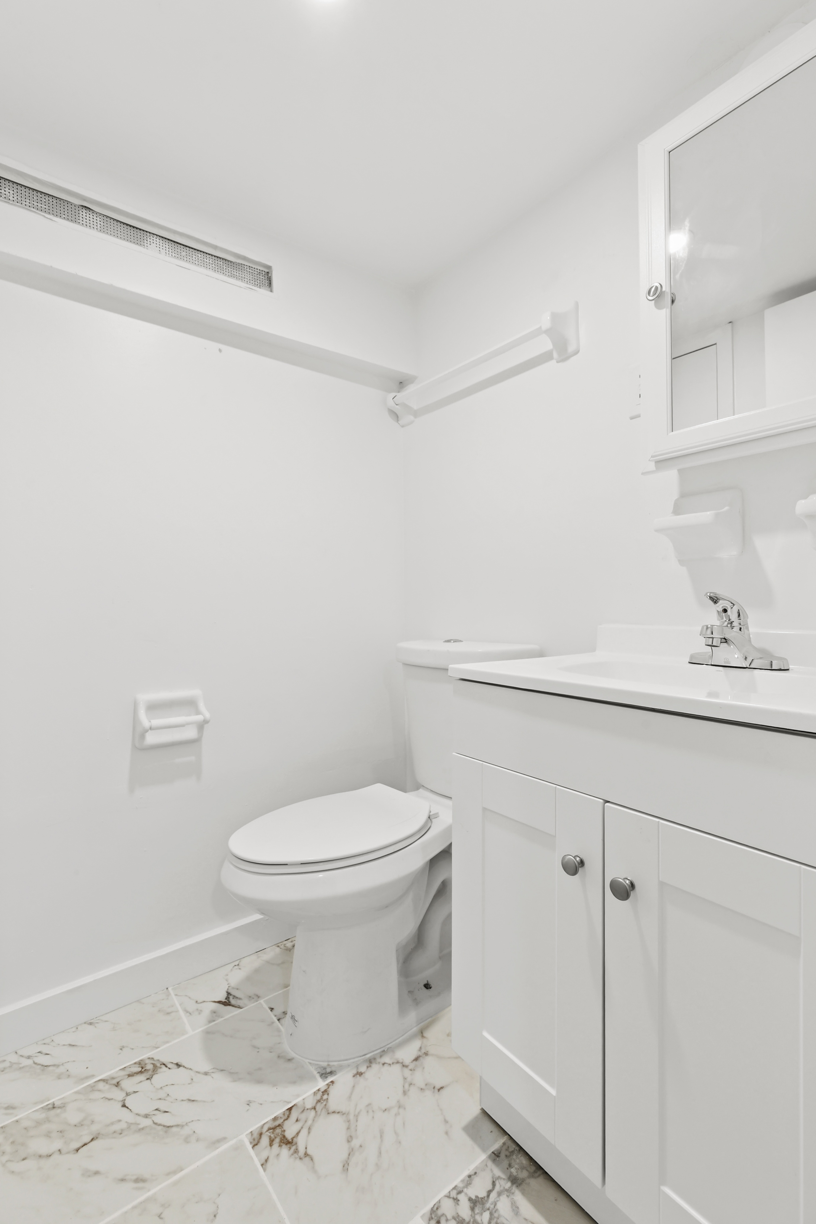 205 West 20th Street, Unit 1A Manhattan, NY 10011 - Photo 7 of 7 a bathroom with a sink a toilet and a shower