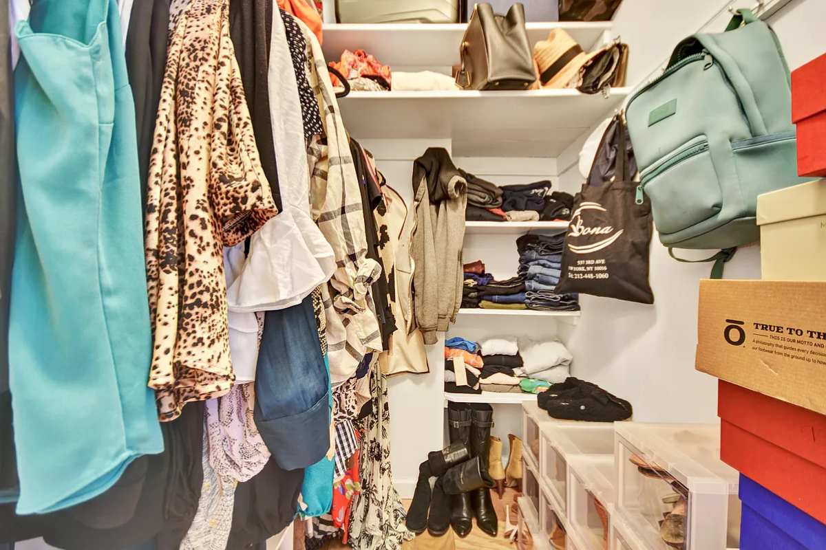 245 East 35th Street, Unit 9D Manhattan, NY 10016 - Photo 5 of 8 a view of walk in closet with clothes and shoes