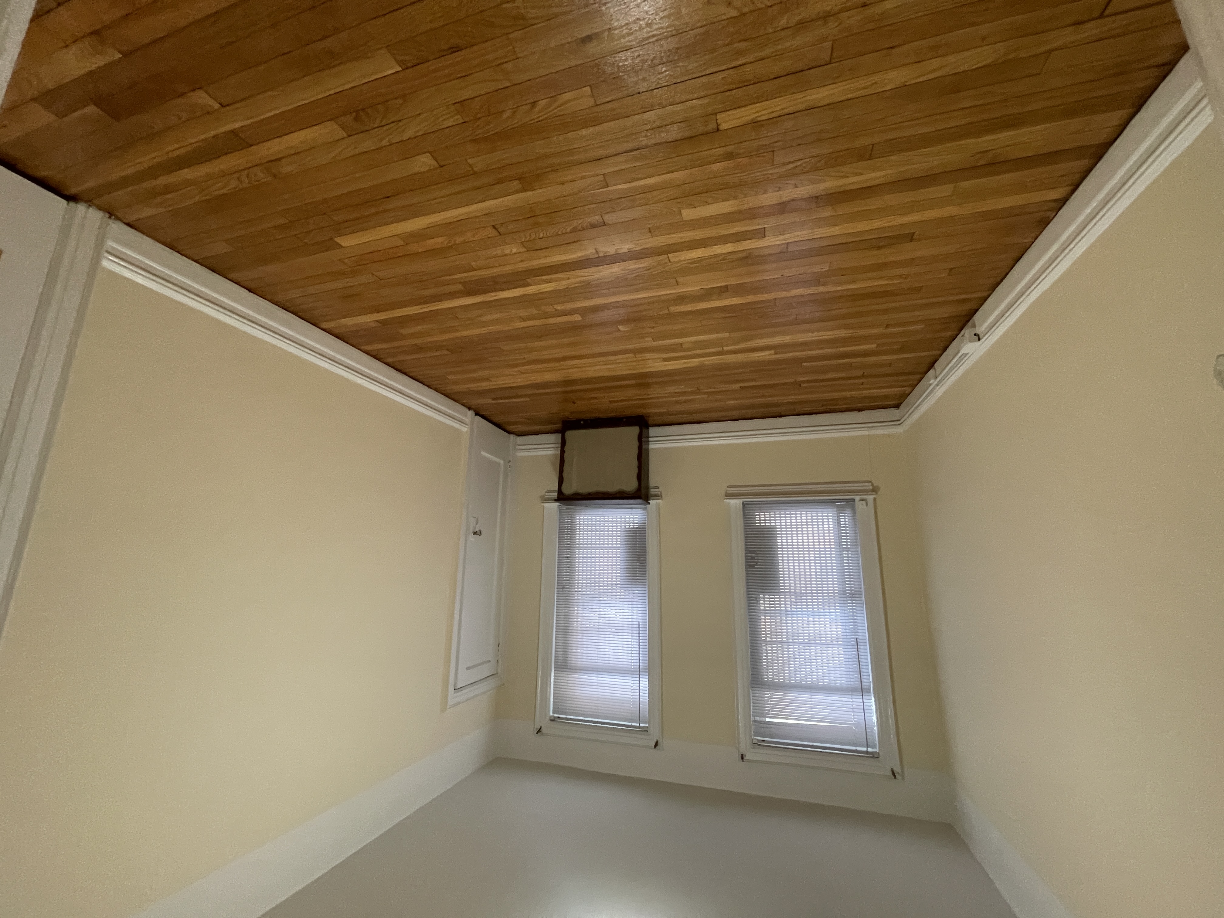 31-74 33rd Street Queens, NY 11106 - Photo 7 of 16 an empty room with wooden floor and windows