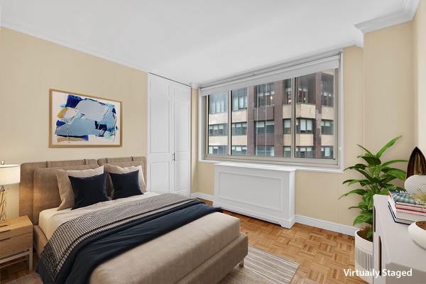 30 West 63rd Street, Unit 7O Manhattan, NY 10023 - Photo 2 of 16 a bedroom with a large bed and a potted plant