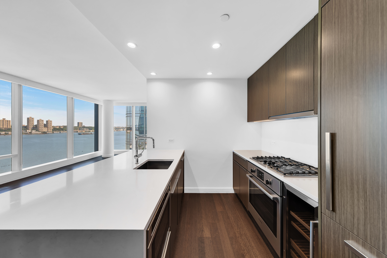 30 Riverside Boulevard, Unit 1414 Manhattan, NY 10069 - Photo 3 of 25 a kitchen with stainless steel appliances a stove and a microwave