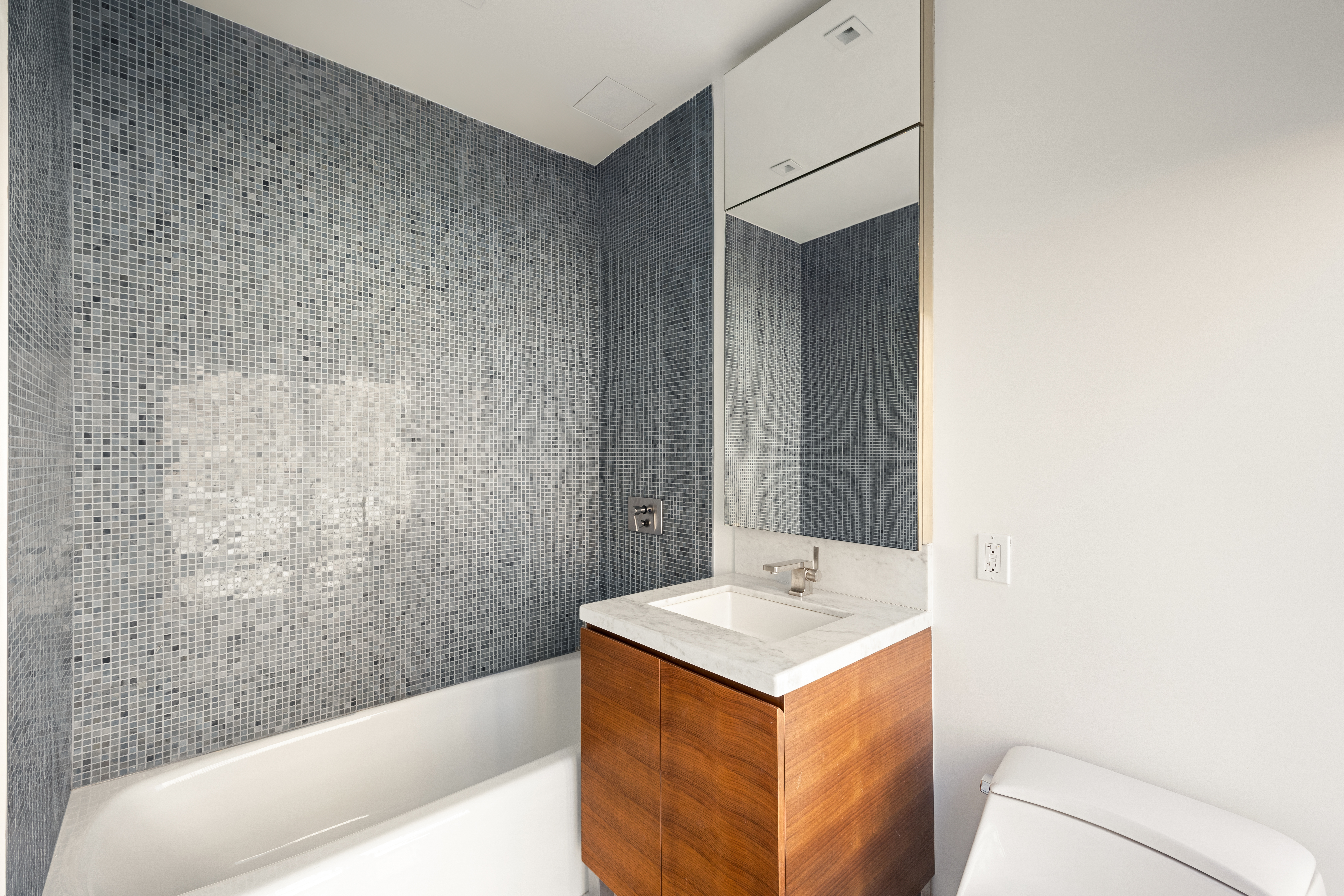 400 West 12th Street, Unit 4J Manhattan, NY 10014 - Photo 11 of 21 a bathroom with a sink and a mirror