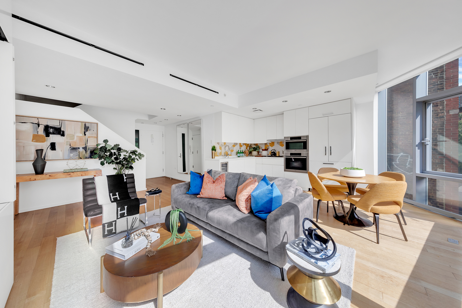 425 West 53rd Street, Unit 419 Manhattan, NY 10019 - Photo 2 of 18 a living room with furniture kitchen view and a refrigerator