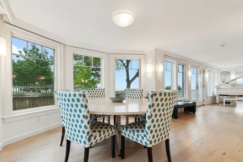 a view of a dining room with furniture wooden floor and garden