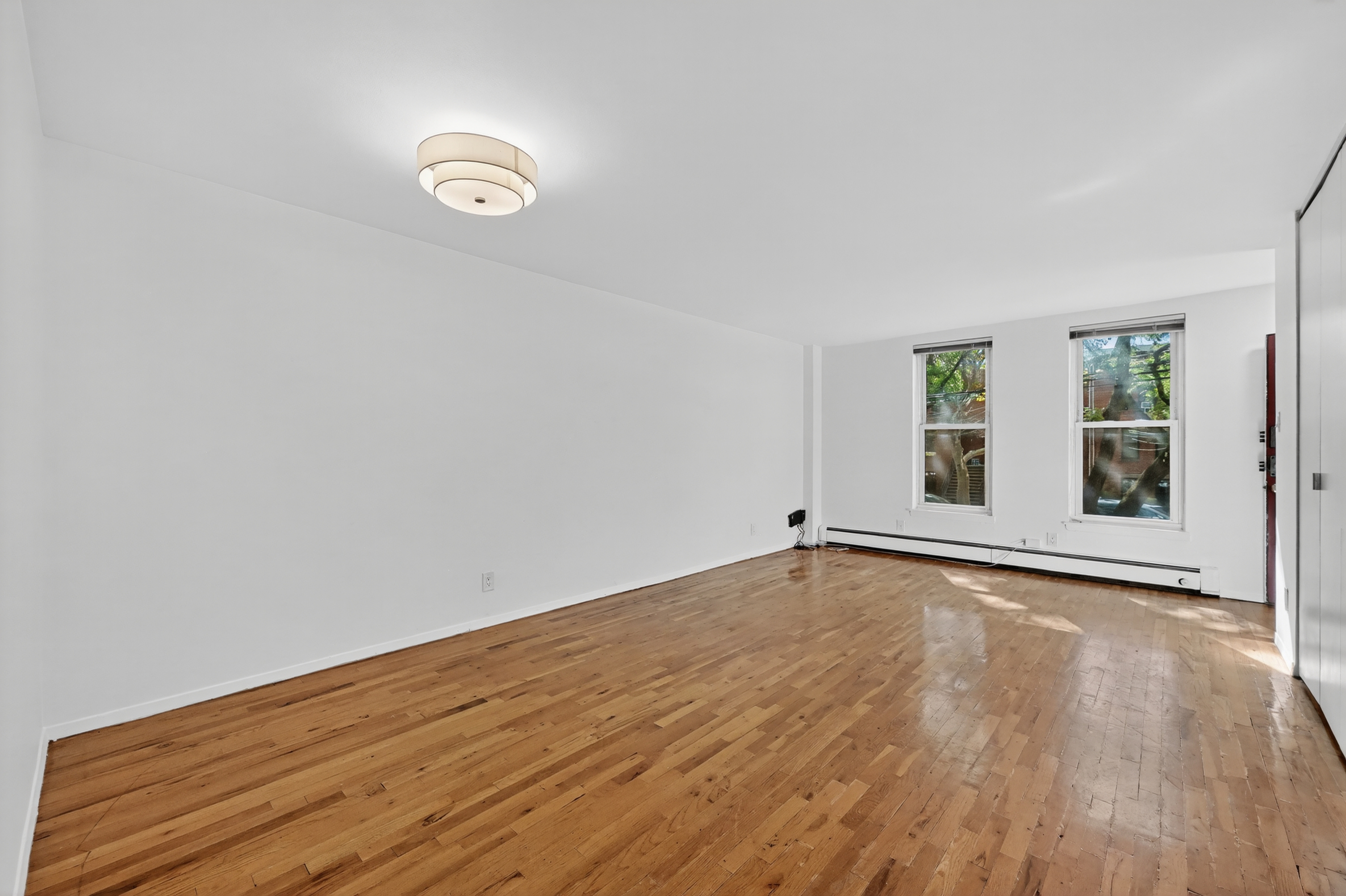 81 President Street, Unit 51-A Brooklyn, NY 11231 - Photo 10 of 27 an empty room with wooden floor and windows