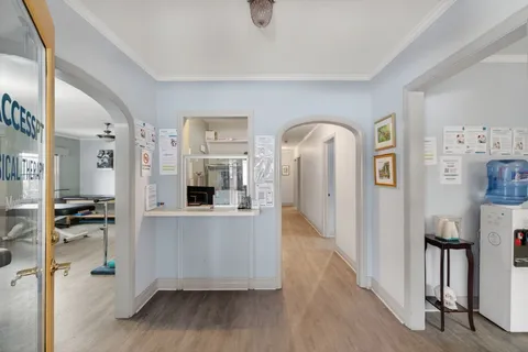 a view of a living room with furniture and wooden floor