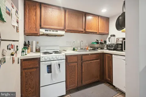 a kitchen with stainless steel appliances granite countertop a sink a stove and cabinets
