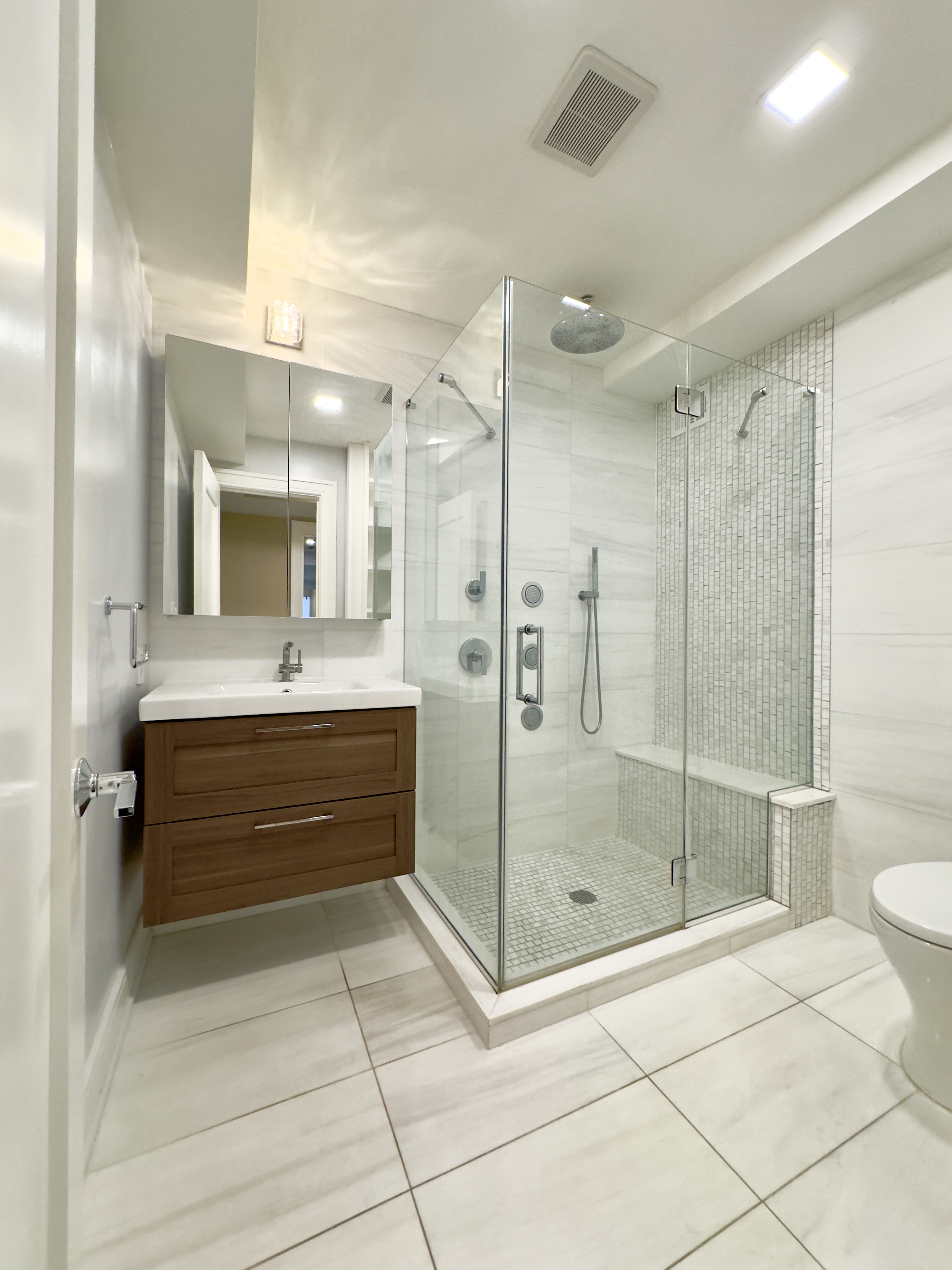 2 Tudor City Place, Unit 12DS Manhattan, NY 10017 - Photo 16 of 20 a bathroom with a shower sink and mirror