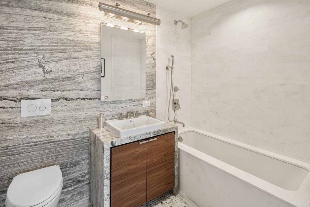 613 Baltic Street, Unit 6C Brooklyn, NY 11217 - Photo 4 of 9 a bathroom with a sink toilet vanity and shower