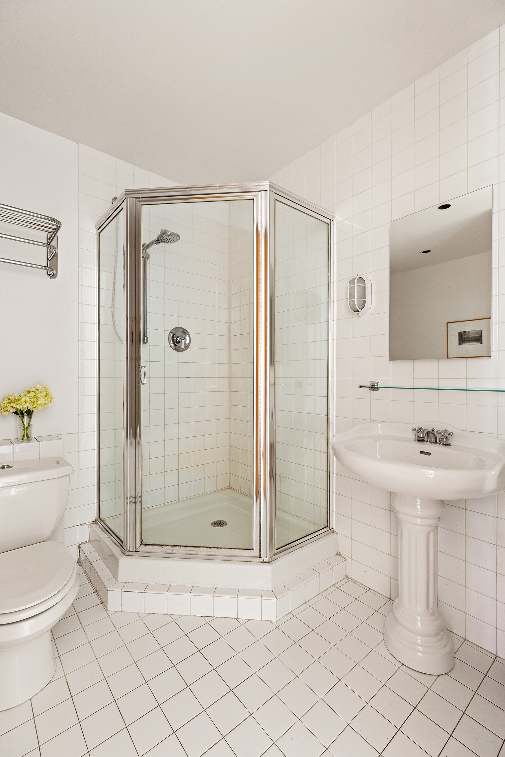 32 West 20th Street, Unit 9B Manhattan, NY 10011 - Photo 10 of 16 a bathroom with a sink a toilet and shower