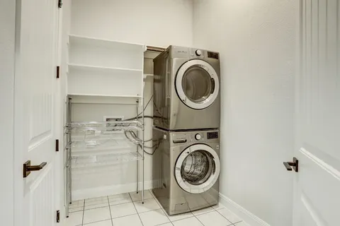 a utility room with sink dryer and washer