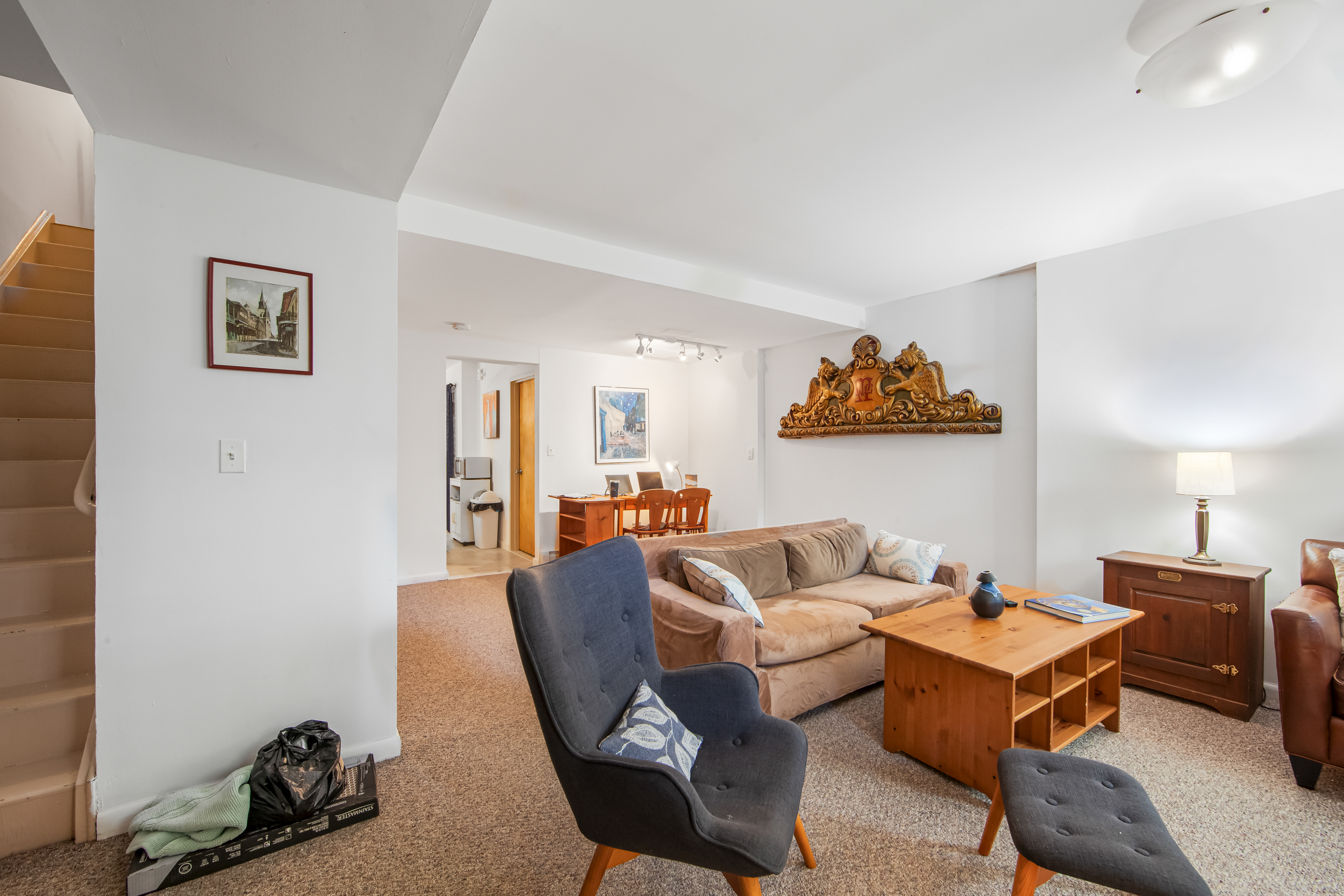 129 Waverly Avenue, Unit 1 Brooklyn, NY 11205 - Photo 4 of 13 a living room with furniture a rug and a wall painting