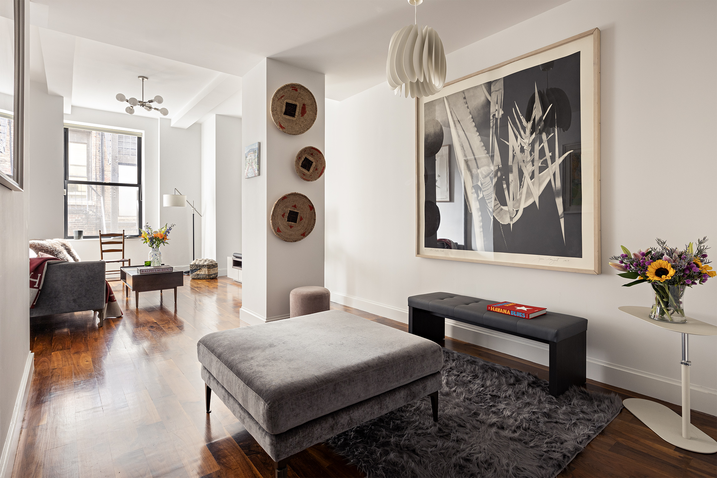 a living room with furniture and wooden floor