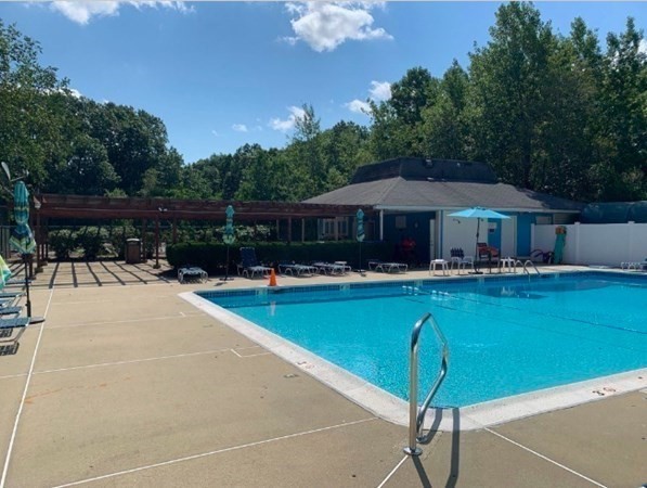 10 Beal's Cove Road, Unit E Hingham, MA 02043 - Photo 11 of 12 a swimming pool with outdoor seating and yard