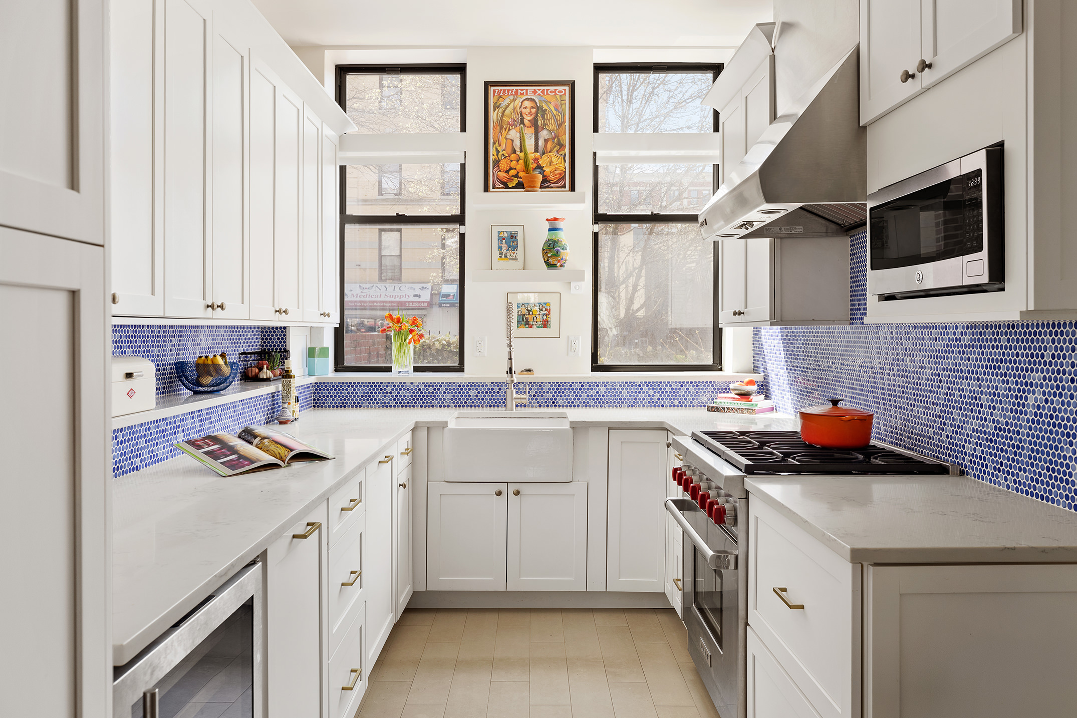 657 West 183rd Street Manhattan, NY 10033 - Photo 3 of 22 a kitchen with stainless steel appliances a stove a sink and a microwave