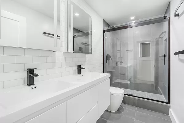 74 Leonard Street, Unit 4B Manhattan, NY 10013 - Photo 5 of 6 a bathroom with a sink a toilet and shower