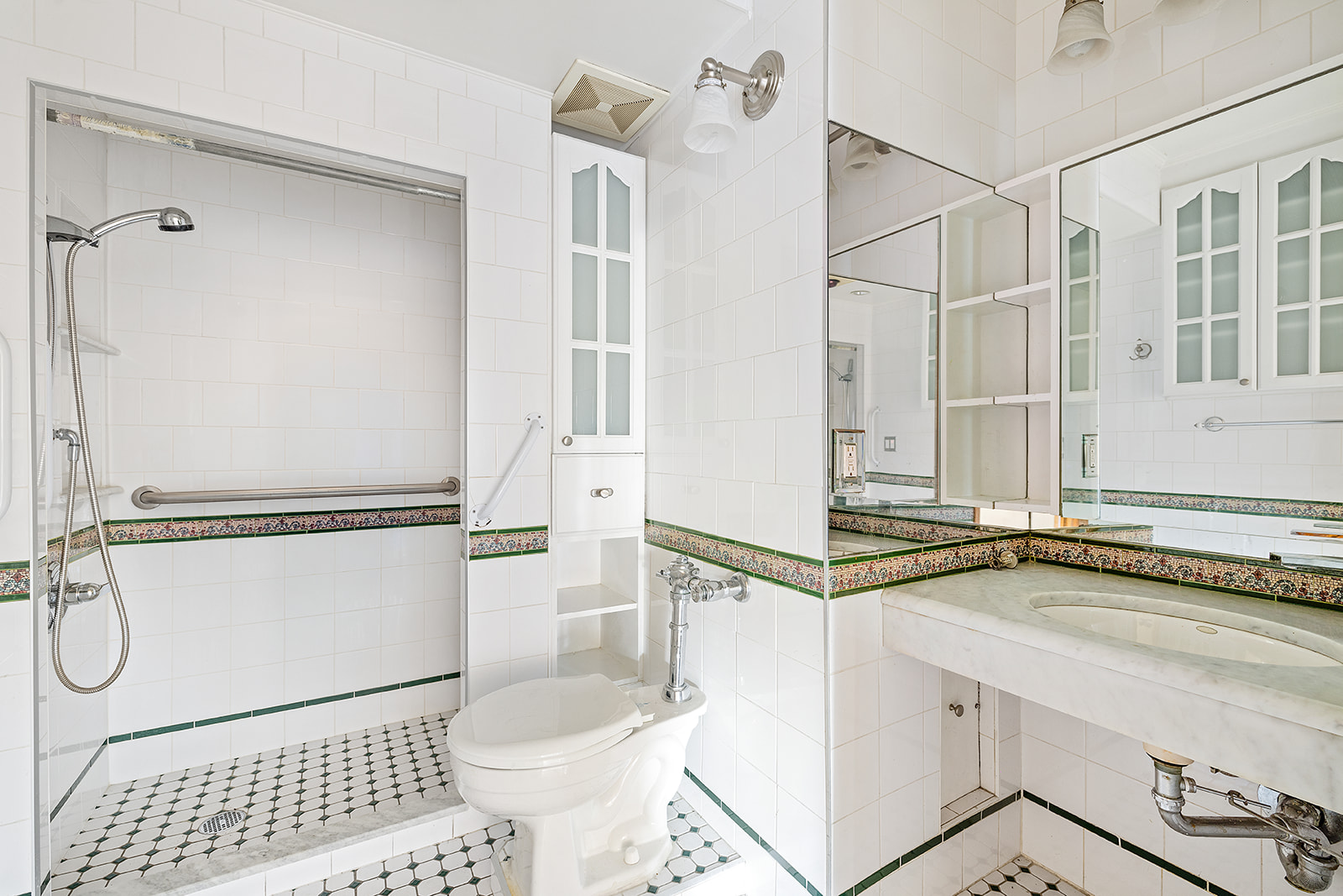 2166 Broadway, Unit 7A Manhattan, NY 10024 - Photo 6 of 8 a bathroom with a granite countertop sink mirror vanity and toilet