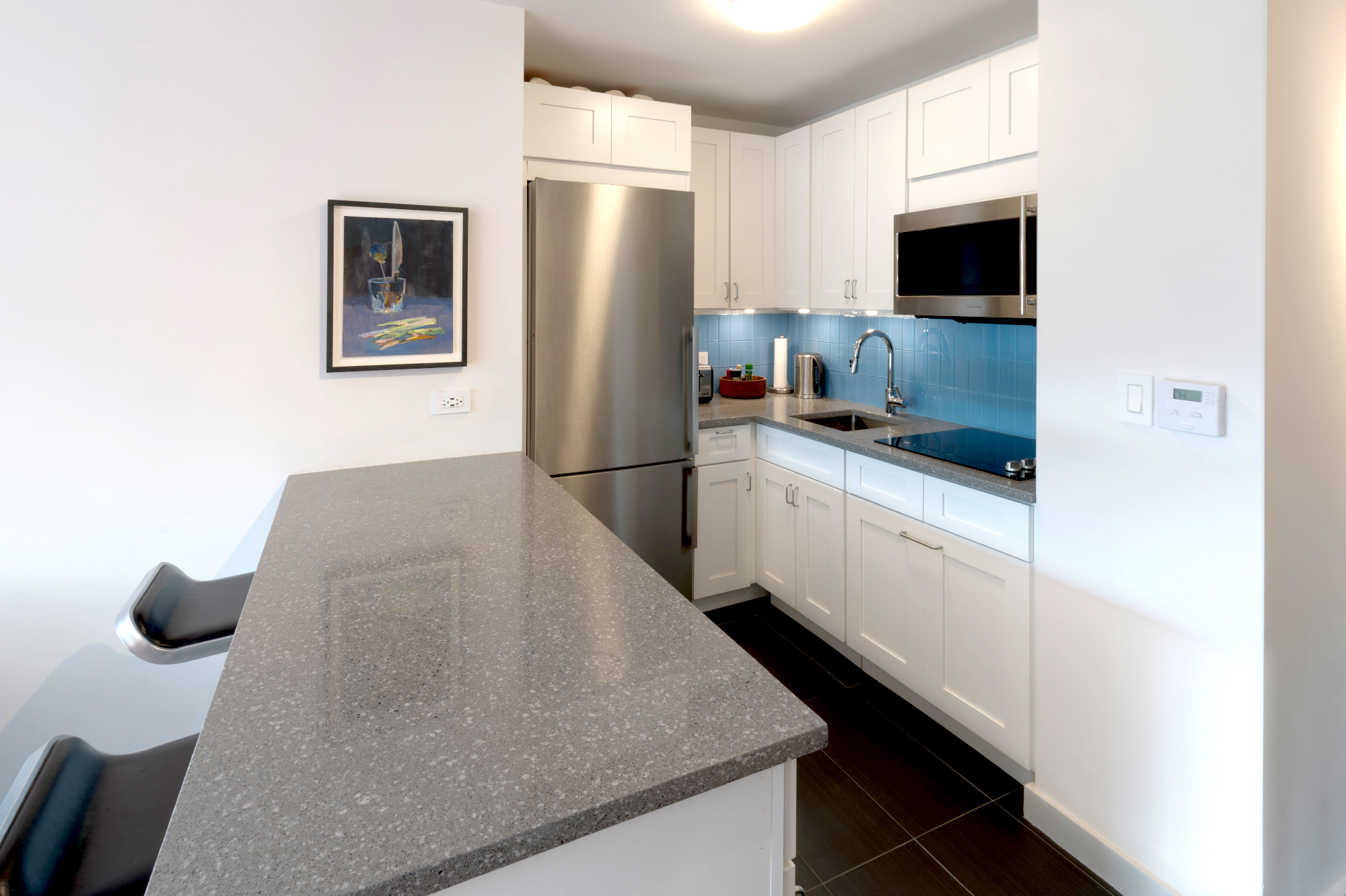 360 West 22nd Street, Unit 7P Manhattan, NY 10011 - Photo 3 of 13 a kitchen with stainless steel appliances granite countertop a refrigerator a stove top oven a sink and dishwasher