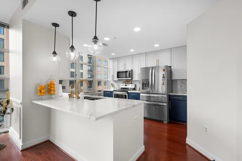 a kitchen with stainless steel appliances a stove a microwave and cabinets