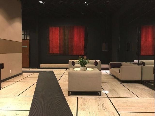 301 East 45th Street, Unit 11F Manhattan, NY 10017 - Photo 8 of 9 a living room with a couch
