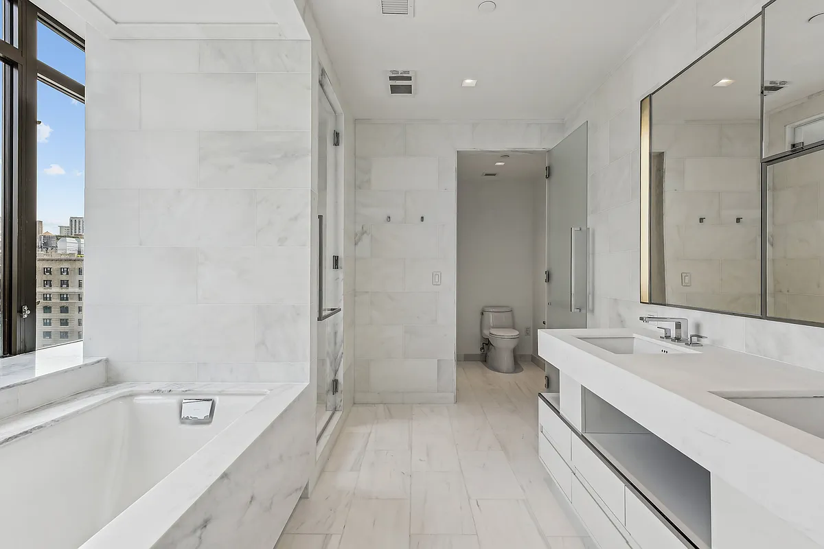 269 West 87th Street, Unit 14A Manhattan, NY 10024 - Photo 7 of 23 a spacious bathroom with a tub sink mirror and a shower