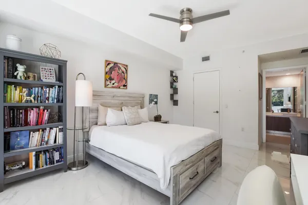 a bedroom with a bed and book shelf