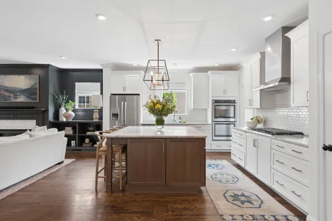 a kitchen with a stove a sink and a refrigerator