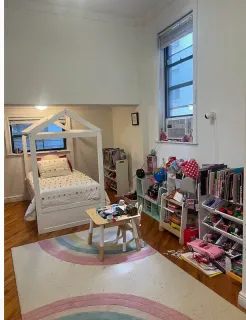 a bedroom with furniture and a book shelf