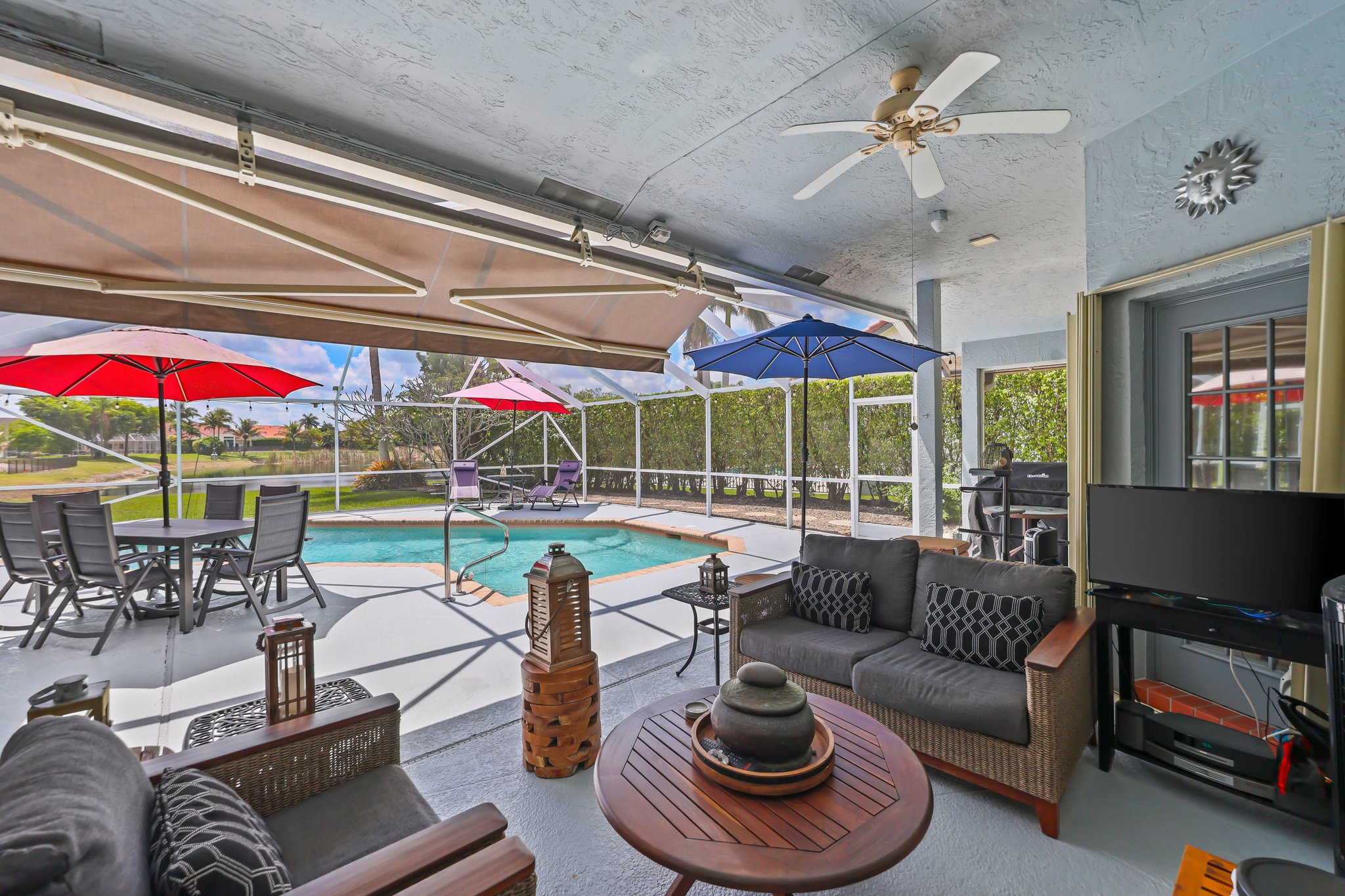 20317 Hacienda Court Boca Raton, FL 33498 - Photo 10 of 100 a living room with lots of furniture and a chandelier