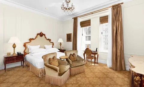 a bed room with a bed and a chair