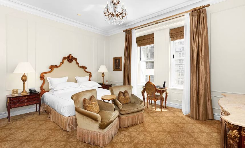 a bed room with a bed and a chair