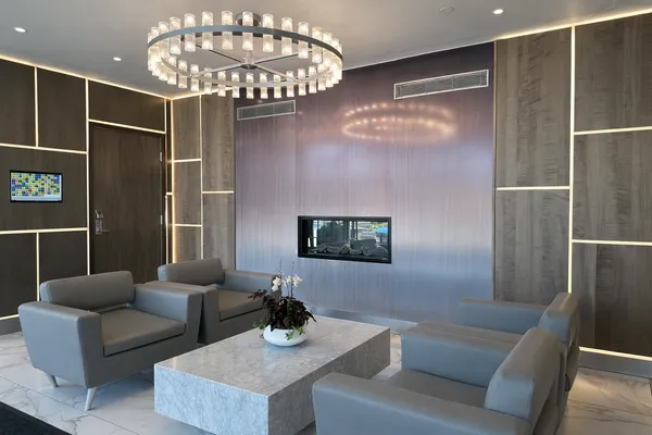 a living room with furniture and a chandelier