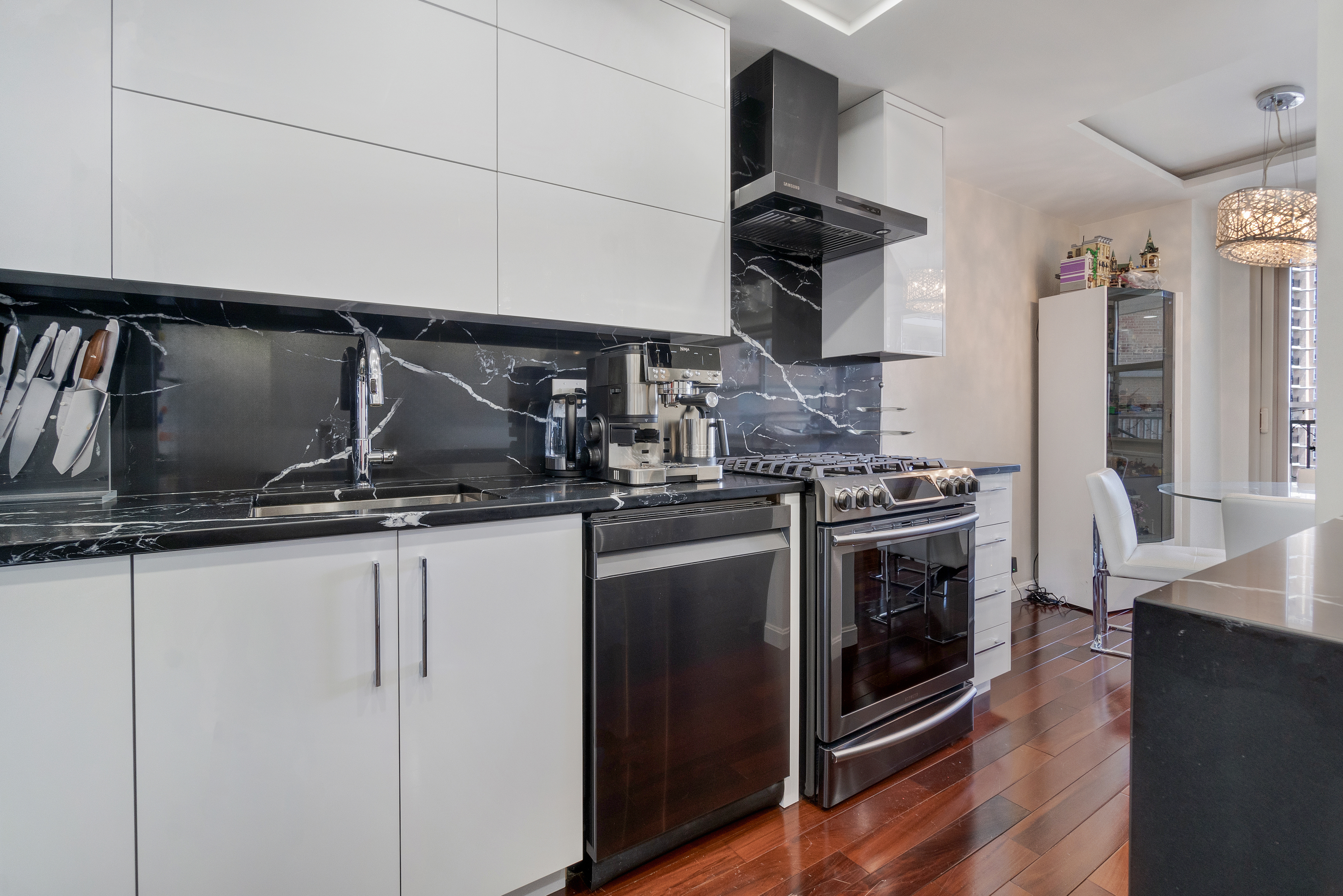 448 Neptune Avenue, Unit 14L Brooklyn, NY 11224 - Photo 4 of 20 a kitchen with stainless steel appliances granite countertop a stove and a sink