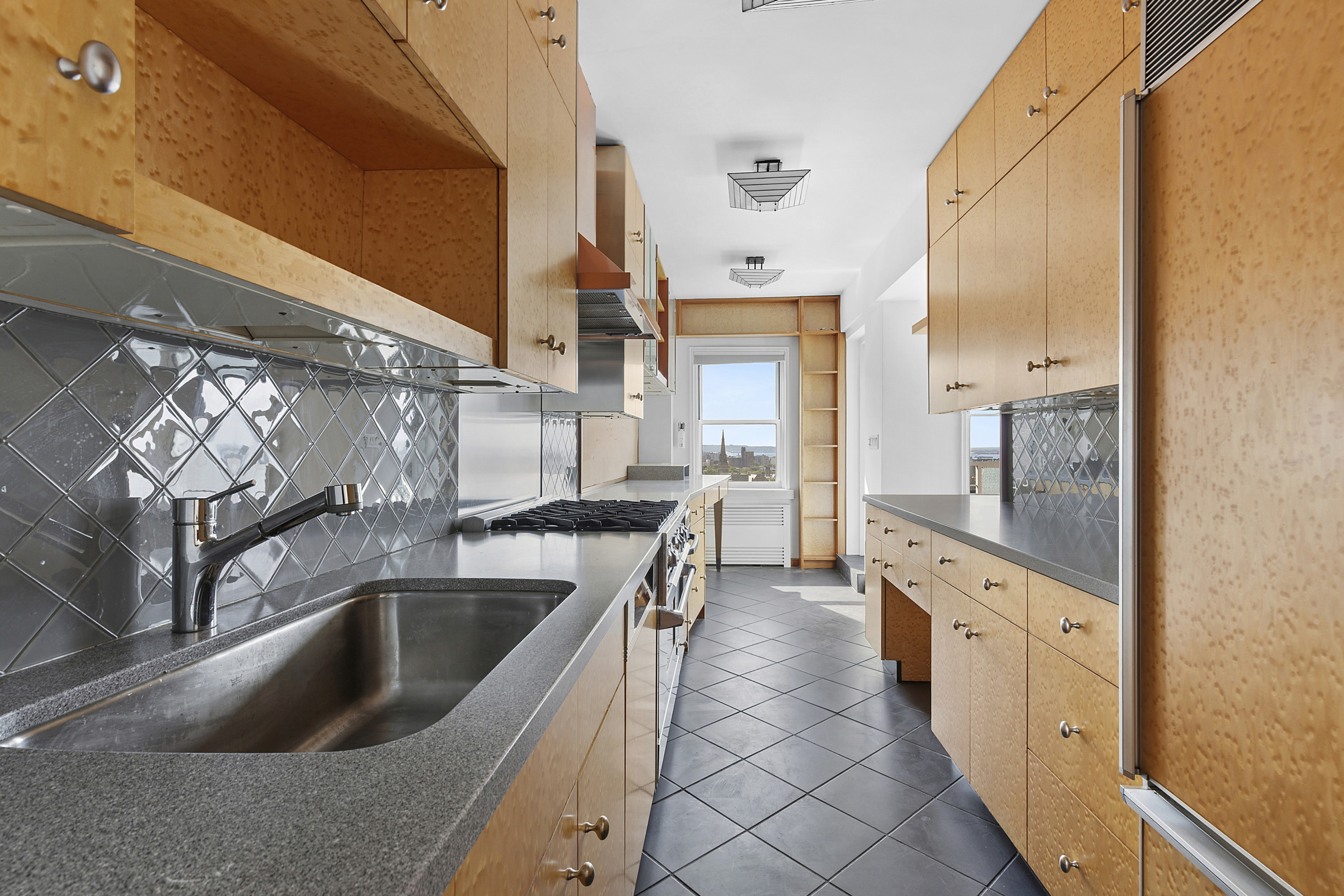 10 Plaza Street East, Unit 16C Brooklyn, NY 11238 - Photo 5 of 6 a kitchen with granite countertop a sink and a refrigerator