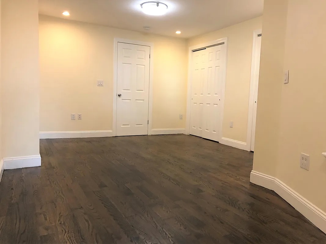 313 Van Buren Street Brooklyn, NY 11221 - Photo 9 of 20 wooden floor in an empty room