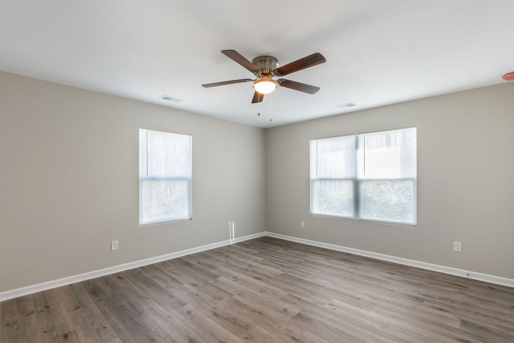 320 Adams Avenue Batesburg, SC 29006 - Photo 25 of 28 a view of an empty room with wooden floor and a window