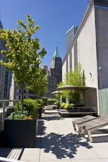 a terrace with outdoor seating and city view