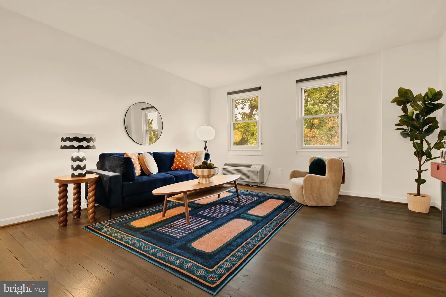 a living room with furniture and wooden floor