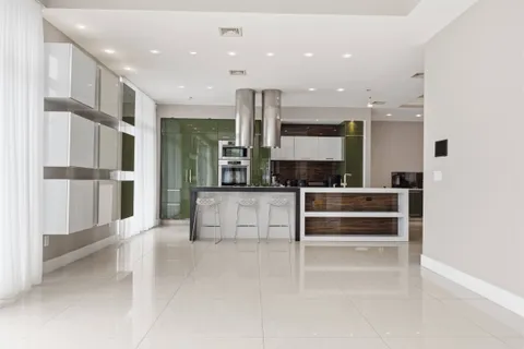a view of kitchen with kitchen island a sink stainless steel appliances and cabinets