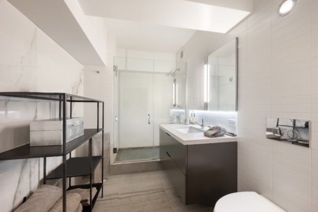 421 Hudson Street, Unit 320 Manhattan, NY 10014 - Photo 11 of 13 a bathroom with a sink toilet and a mirror