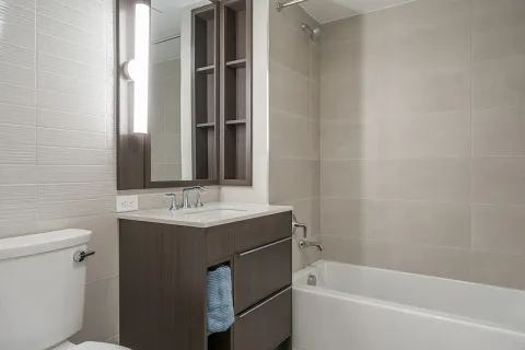 a bathroom with a granite countertop sink toilet and bathtub