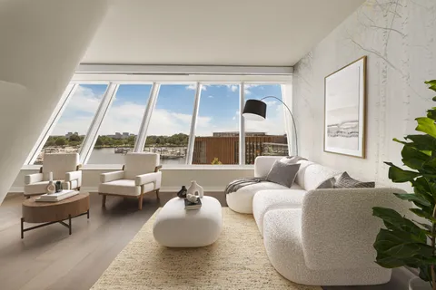 a living room with fireplace furniture and a large window