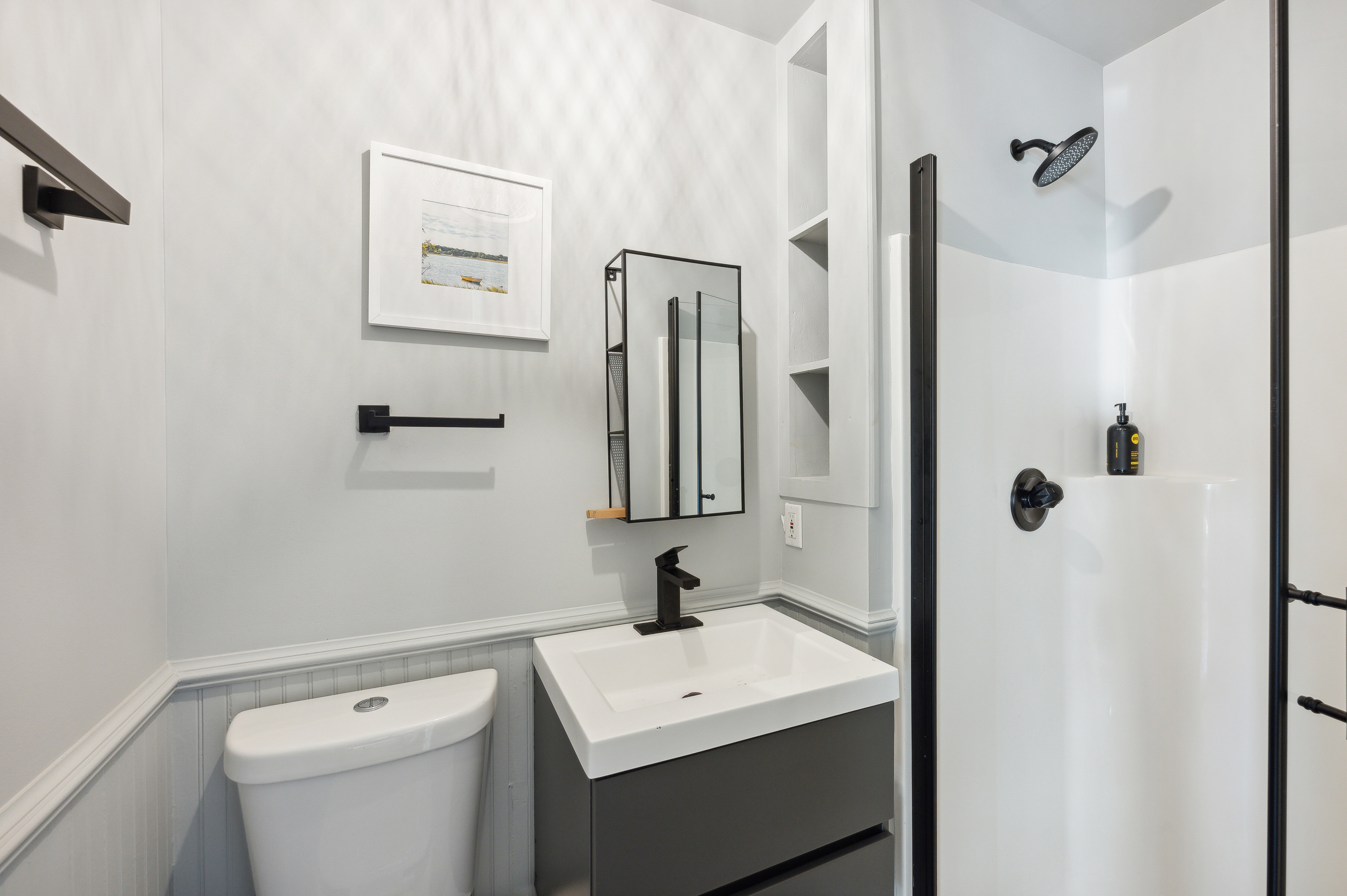 32 Lighthouse Road Hampton Bays, NY 11946 - Photo 50 of 51 a bathroom with a toilet a sink and mirror