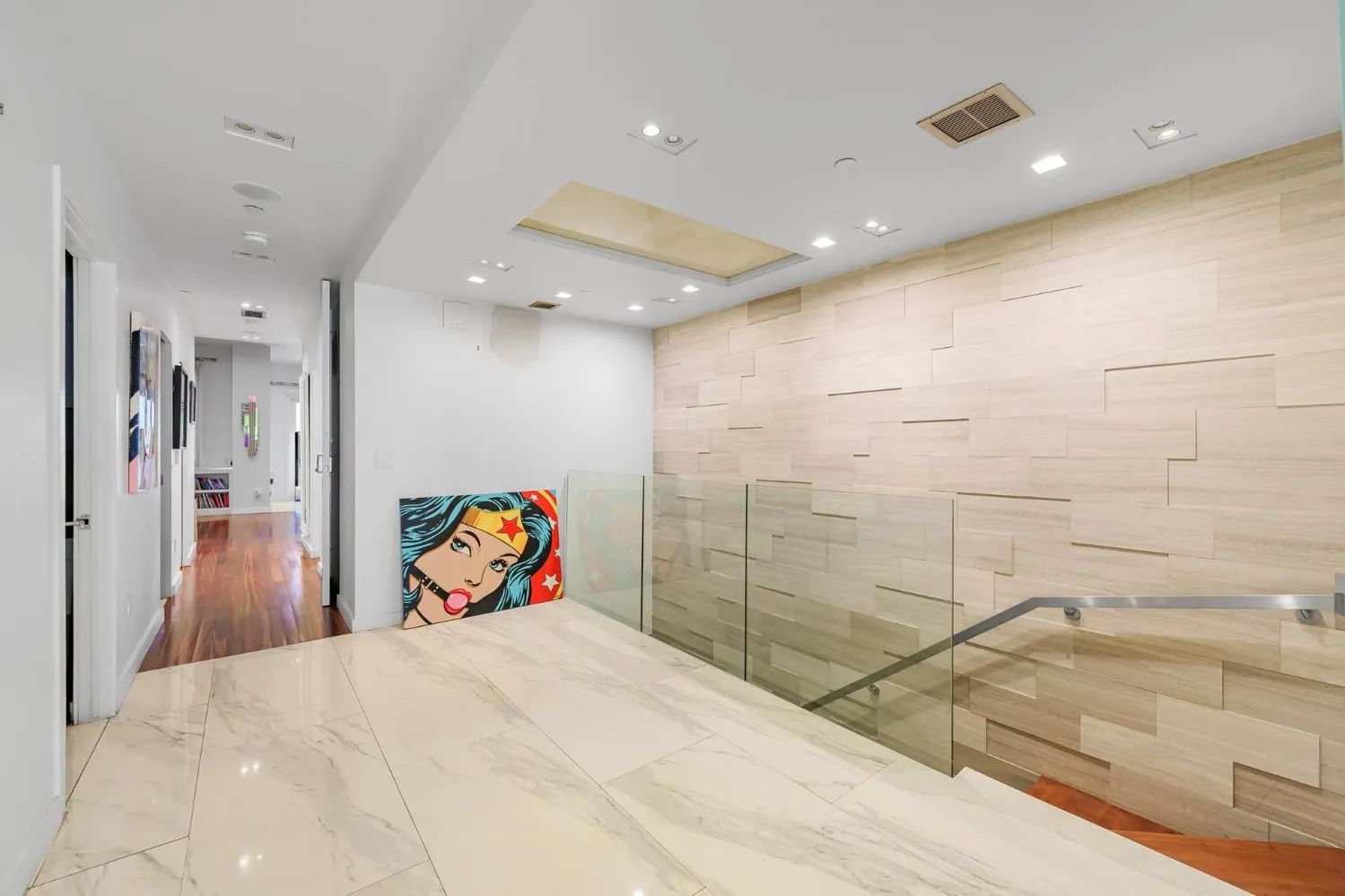 a view of a hallway with wooden floor