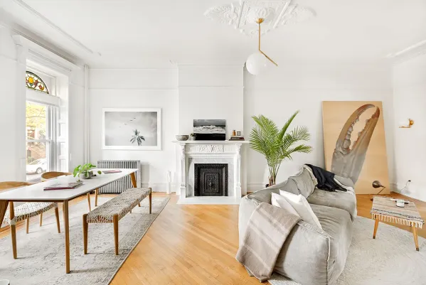 a living room with furniture mirror and fireplace