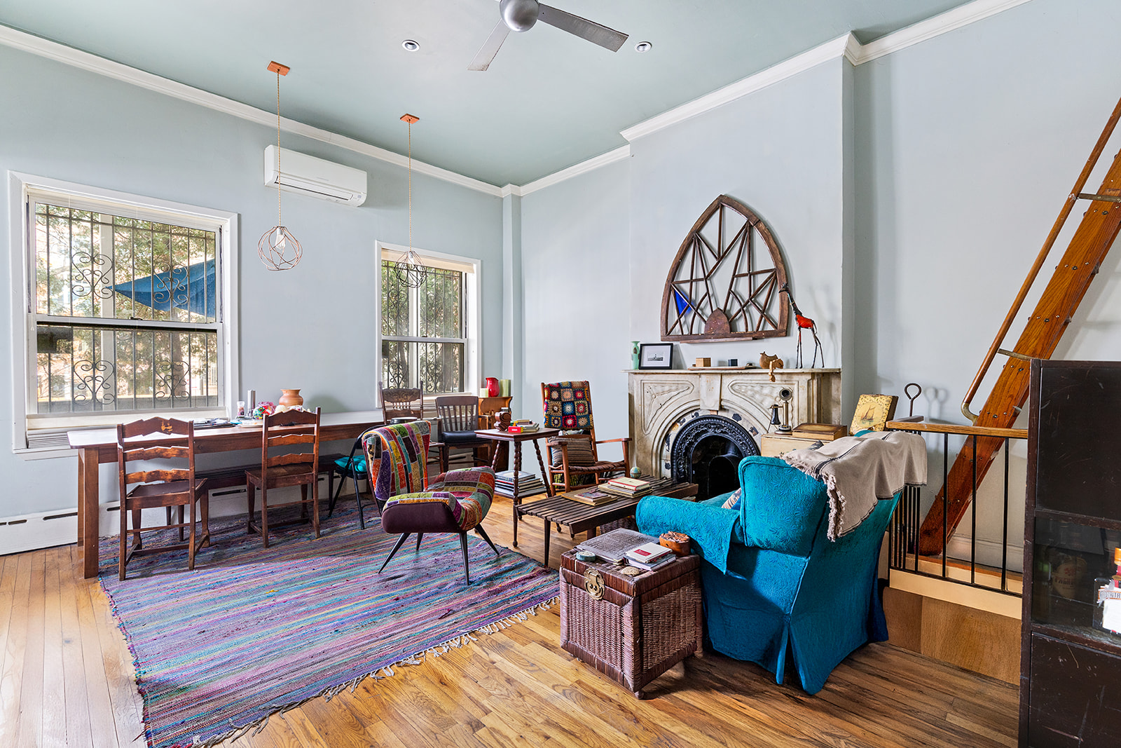 a living room with furniture a fireplace and wooden floor