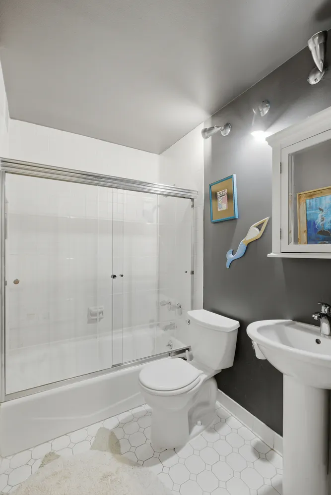 a bathroom with a toilet a sink and bathtub